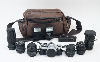 A Canon AE-1 SLR camera, chrome, serial no. 3517711, with Canon bodycap and manual, together with a selection of Canon FD lenses including: a 28mm 1:2.8, a 35mm 1:2, a 50mm 1:1.8, a 100mm 1:2.8, a 200mm 1:4, and a 35-105mm 1:3.5, each with lens...