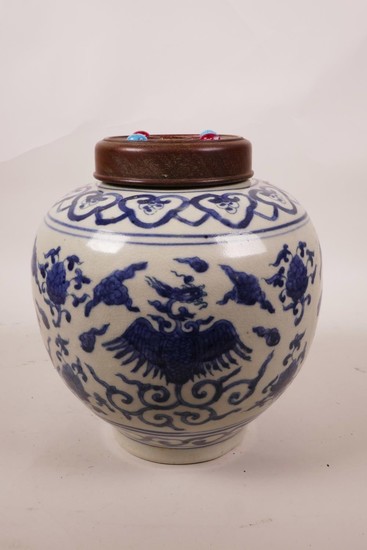 A Chinese blue and white ginger jar and wood cover, with pho...