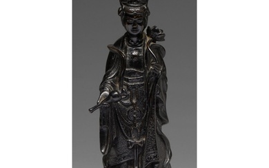 A Chinese bronze figure of Guanyin, 19th c, a lotus and flas...