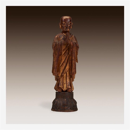 A Chinese gilt wood figural carving of a standing...