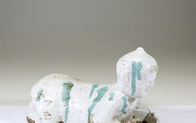 A Chinese green-splashed white glazed pottery boy-form