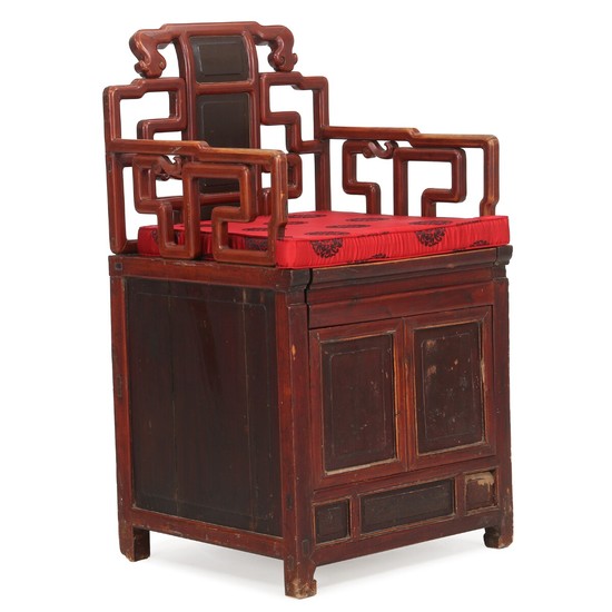 A Chinese hardwood armchair with compartment underneath the seat. First half of the 20th century. Modern cushion.