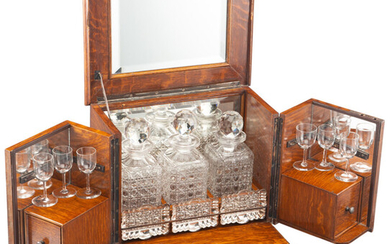 A French Mahogany Cave à Liqueur with Three Cut-Glass Decanters, Six Cordial Glasses, and Three Metal Trays