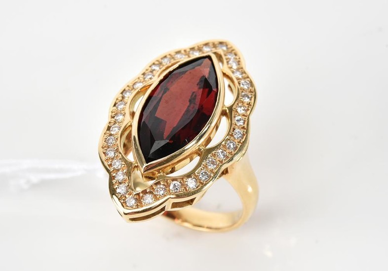 A GARNET AND DIAMOND DRESS RING IN 18CT GOLD