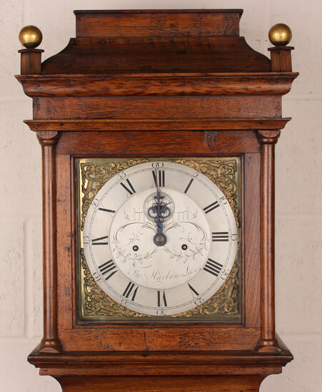 A George III oak longcase clock with eight day movement striking on a bell, the 11-inch square brass