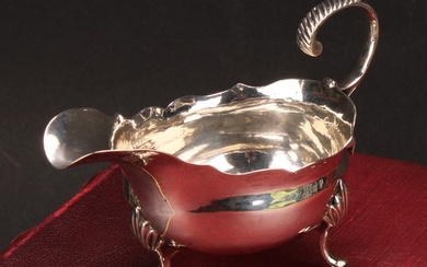 A George III silver sauce boat, acanthus-capped flying scrol...