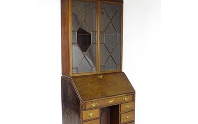 A Georgian mahogany bureau bookcase, with a moulded top abov...