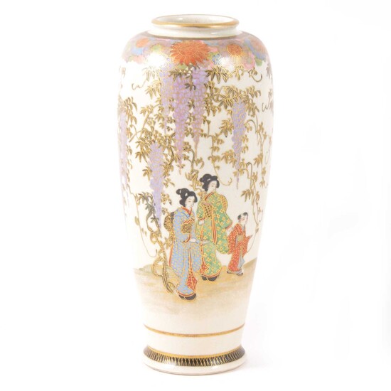 A Japanese Satsuma slender vase decorated with figures and trailing wisteria.