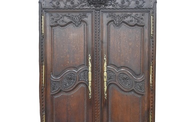 A Louis XVI French provincial carved walnut armoire, 227cm h...