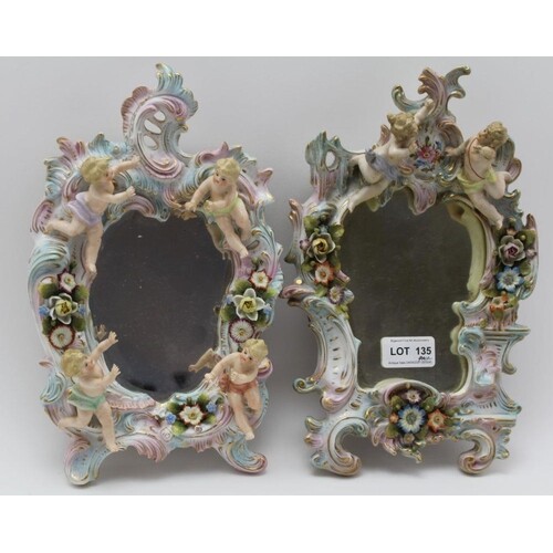 A PAIR OF SITZENDORF PORCELAIN WALL MIRRORS, scroll fork fra...