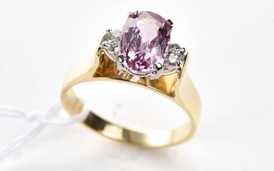 A PINK SPINEL AND DIAMOND DRESS RING IN 18CT TWO TONE GOLD, THE OVAL CUT SPINEL WEIGHING 2CTS, SIZE O, 4.7GMS