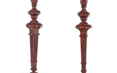 A Pair of Continental Carved Walnut Torcheres