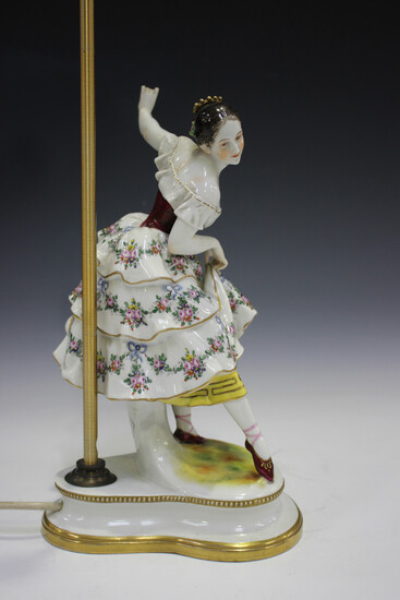 A Thuringian Rudolstadt Volkstedt porcelain figural table lamp, early 20th century, modelled as a ba