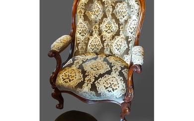 A Victorian mahogany drawing room armchair with a button uph...