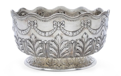 A Victorian silver punch bowl, London, 1888, Sibray, Hall & Co., the body repousse decorated with ribbon-tied laurel garlands to a wavy gadrooned rim, the lower body with foliate design raised on a low circular foot, 13.5cm high, 24.7cm dia...