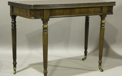 A William IV mahogany fold-over tea table with a reeded edge top and reeded legs, terminating in bra