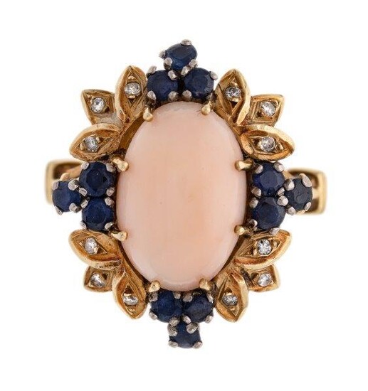 A coral, sapphire and diamond ring, of cluster design, centring on an oval coral corallium rubrum cabochon, within a leaf surround accented with circular-cut sapphires and single-cut diamonds, c. 1960 ring size P