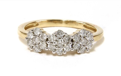 A gold diamond triple cluster ring