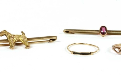 A gold dog bar brooch