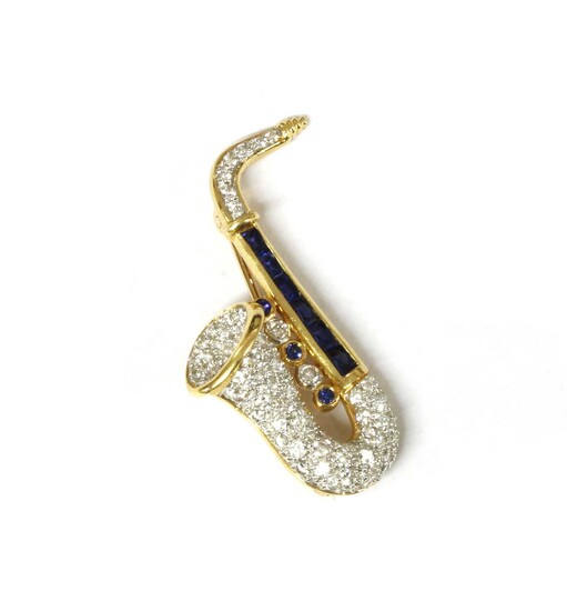 A gold sapphire and diamond novelty saxophone brooch