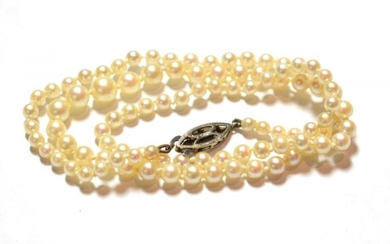 A graduated cultured pearl necklace, clasp stamped '9' and '.375',...