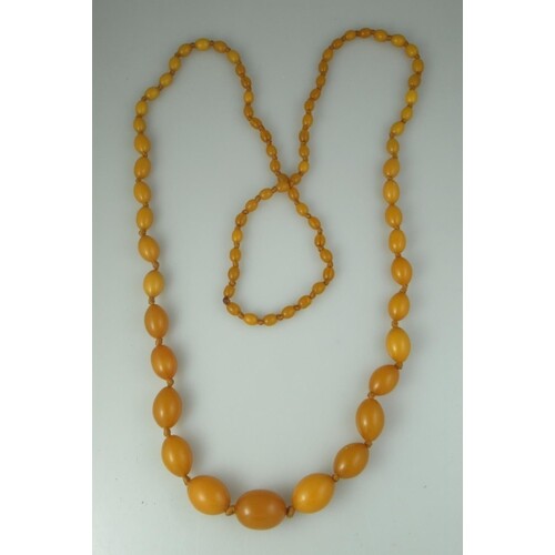 A graduated string of amber beads. The largest approx 25mm ...