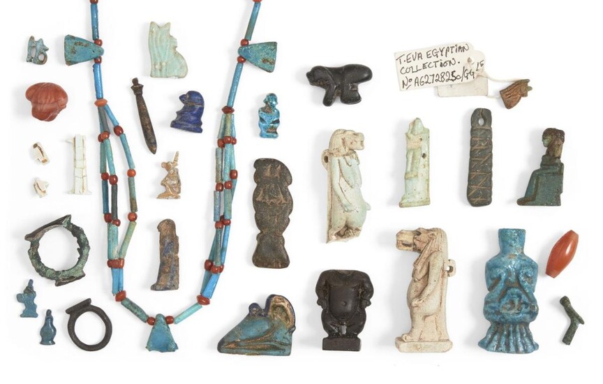 A group of 26 Egyptian amuletic pieces, including rings, in faience, stone and bronze, 18th dynasty and later; and an Egyptian faience necklace (26) Provenance: The necklace Ex-Julian Bird collection (1974-2014); a bronze ring Christie's 27...
