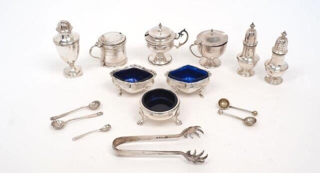 A group of silver cruets comprising: a George III pepper shaker, London, 1788, maker's mark rubbed; a George III silver salt with blue glass liner, London, 1768, George Smith (II); a pair of baluster shaped pepper shakers, Birmingham, 1929, Mappin...