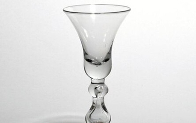 A heavy baluster glass c.1710, with a generous bell bowl...