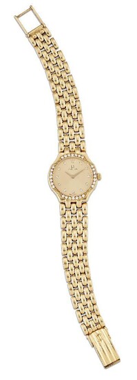 A lady's 18ct gold and diamond quartz wristwatch, by Omega, the champagne dial with diamond dot markers and Roman black numeral at 12, Signed Omega, the bezel set at intervals with seven single-cut diamonds, quartz movement, the case back secured...