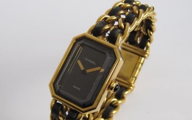 A lady's Chanel quartz Wristwatch the rectagular black dial...