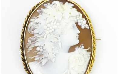 A large cameo brooch with carved cameo to centre depicting b...