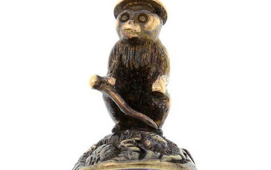 A late 19th century gold foil-back paste fob seal, designed to depict a novelty seated monkey.