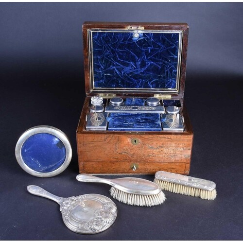 A matched silver-backed dressing table set, comprising a mir...