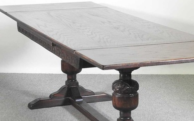 A mid 20th century oak draw leaf dining table, on...