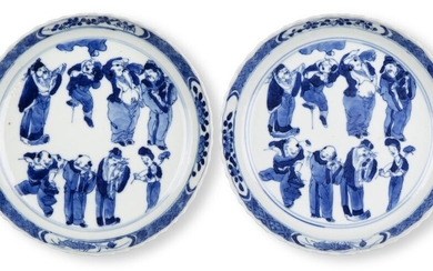 A pair of Chinese porcelain blue and white 'Immortals' saucer dishes, 18th century, each finely painted to the central reserve with the Eight Daoist Immortals inside a border of prunus blossom, underglaze blue four character Kangxi mark inside a...