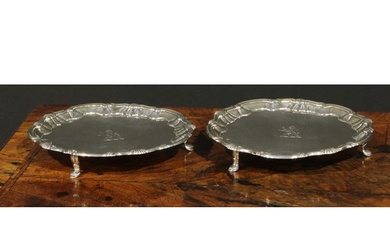 A pair of George II silver shaped circular salvers, fluted s...
