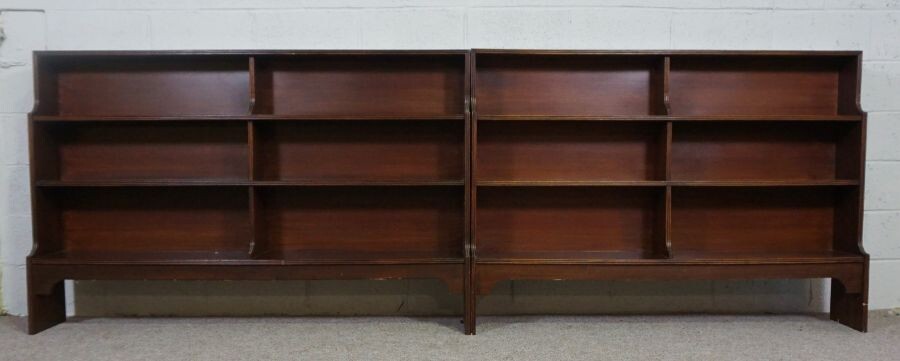 A pair of George III style mahogany waterfall open bookcases, 20th century, each with three