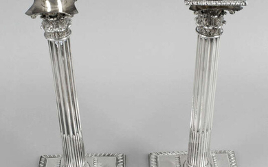 A pair of Irish cast silver Corinthian column candlesticks, probably George III.