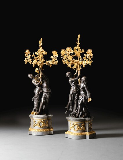 A pair of Louis XVI patinated gilt-bronze candelabra, circa 1785 | Paire de grands candélabres en bronze patiné et doré d'époque Louis XVI, vers 1785