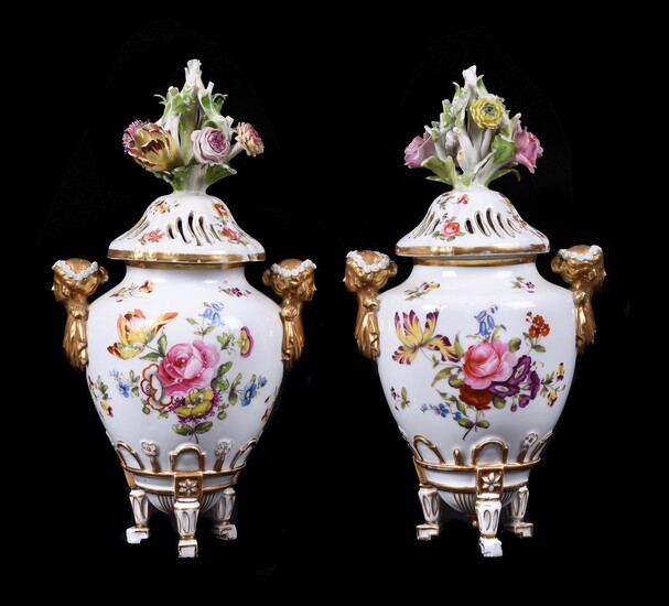A pair of Meissen pot pourri urns and pierced covers