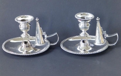 A pair of Regency crested silver chambersticks of plain...