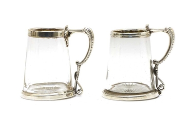 A pair of Victorian silver mounted glass mugs