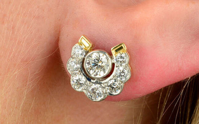 A pair of brilliant-cut diamond horseshoe earrings.