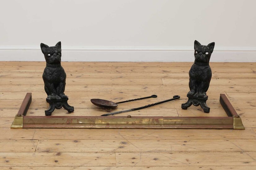 A pair of cast iron French bulldog firedogs