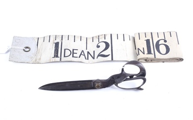 A pair of early 20th century tailor's shears and a Dean novelty tape measure.