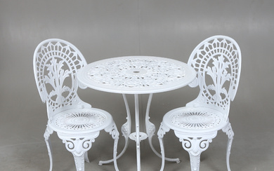 A pair of garden chairs and a table.