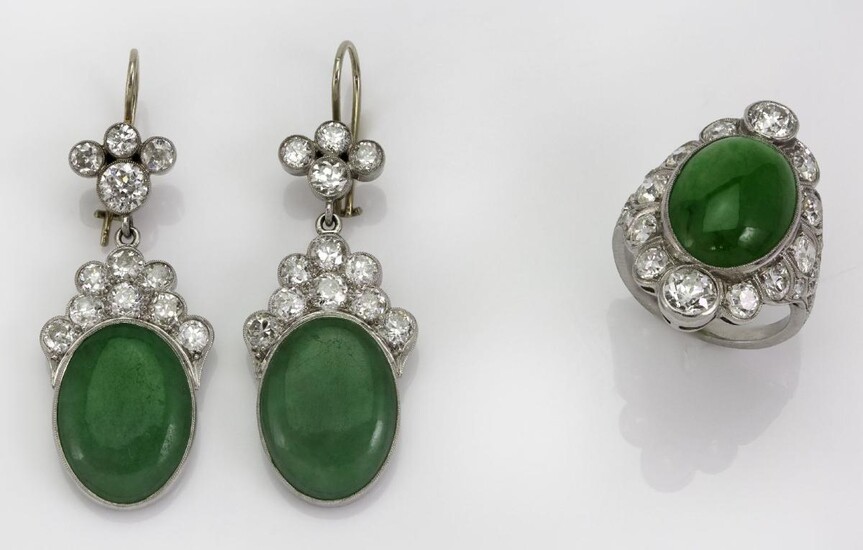 A pair of jadeite jade and diamond earrings and ring, the earrings each centring on an oval cabochon jade to a scalloped millegrain surmount of circular-cut diamonds, hook fittings, the ring of matching design to leaf engraved shoulders, stamped...