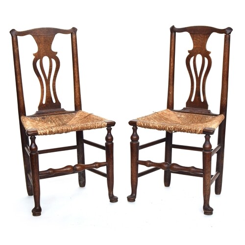 A pair of oak splat back chairs with rush seats
