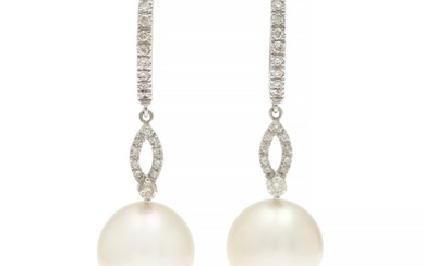 A pair of pearl and diamond ear pendants each set with a cultured South Sea pearl and numerous brilliant-cut diamonds, mounted in 18k white gold. L. 4 cm.
